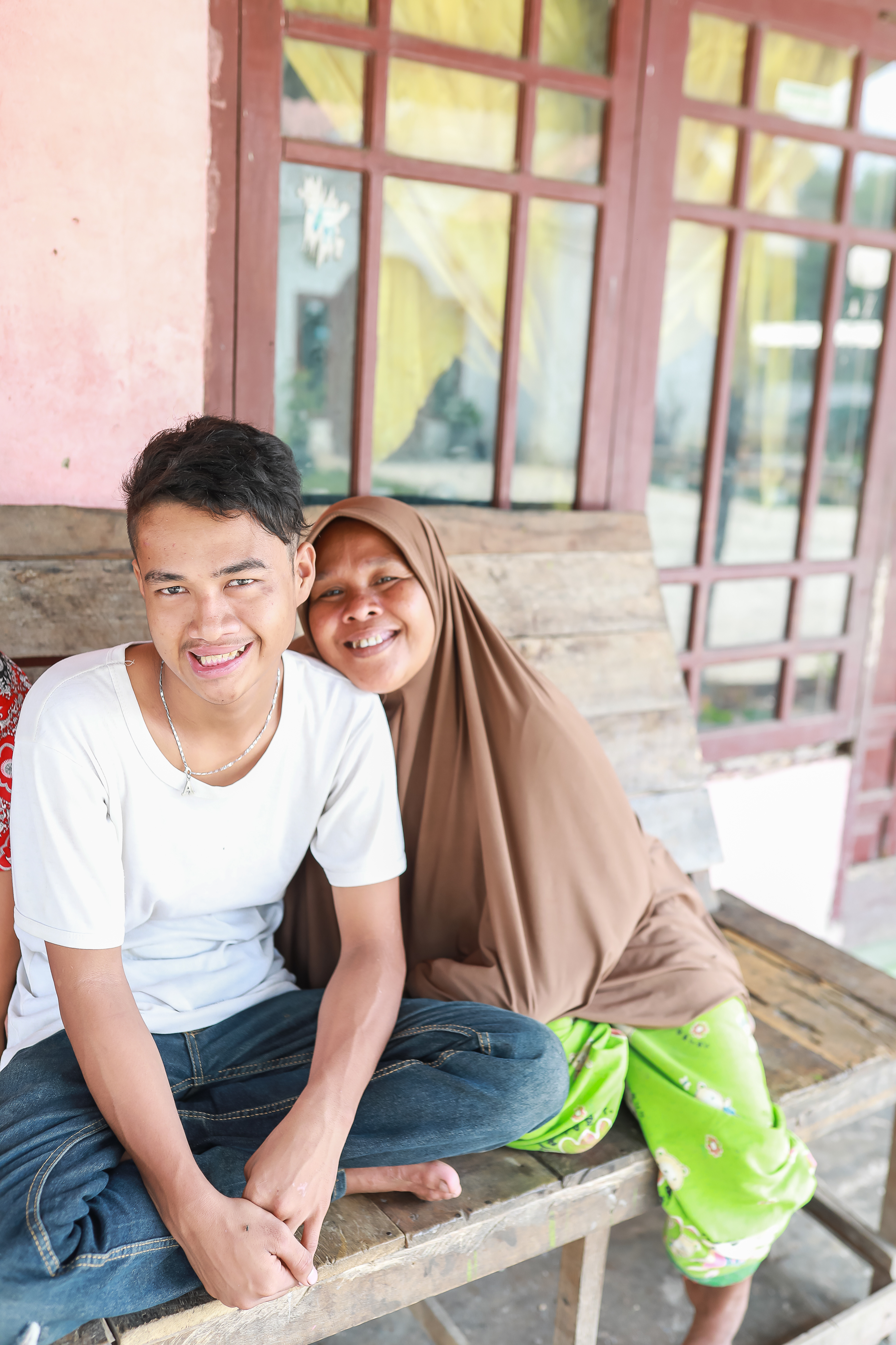 Angga smiling with his mother Nurelela after cleft surgery