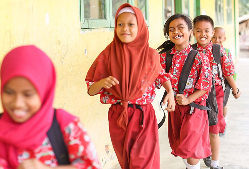 Aira smiling at school after cleft surgery