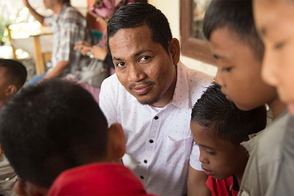 Rahmat smiling with kids