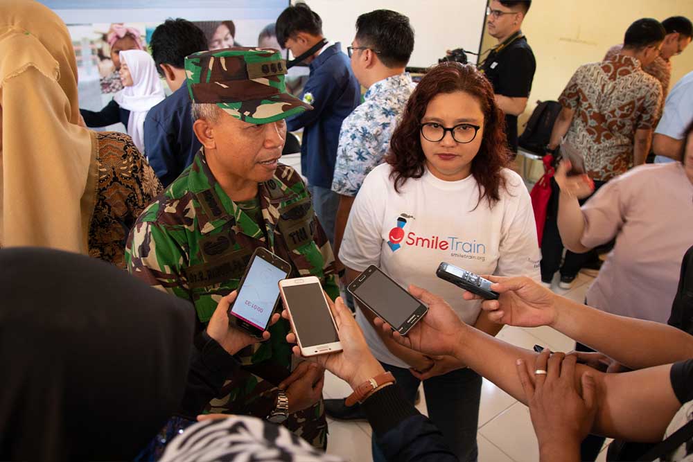 Deasy Larasati and an Indonesian soldier answering questions in an interview