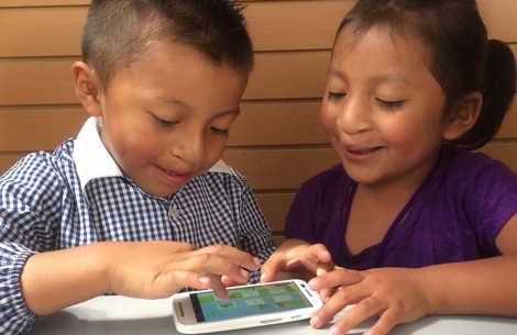 Cleft-affected children smiling and using Smile Train's speech therapy app