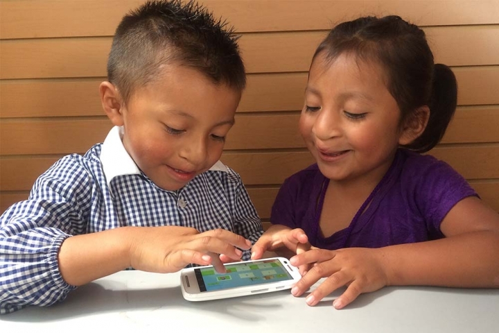 children smiling and using Smile Train's speech app
